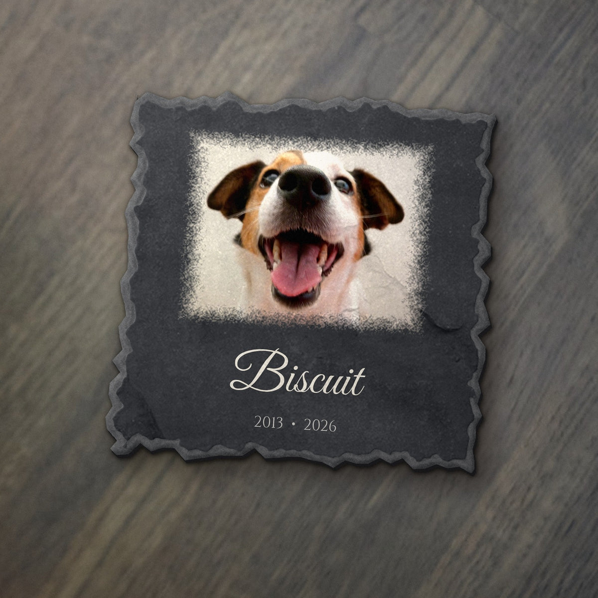 Custom pet photo keepsake: a smiling dog's photo printed in full color on an 8x8 slate panel with the sample name Biscuit and dates (product mockup)