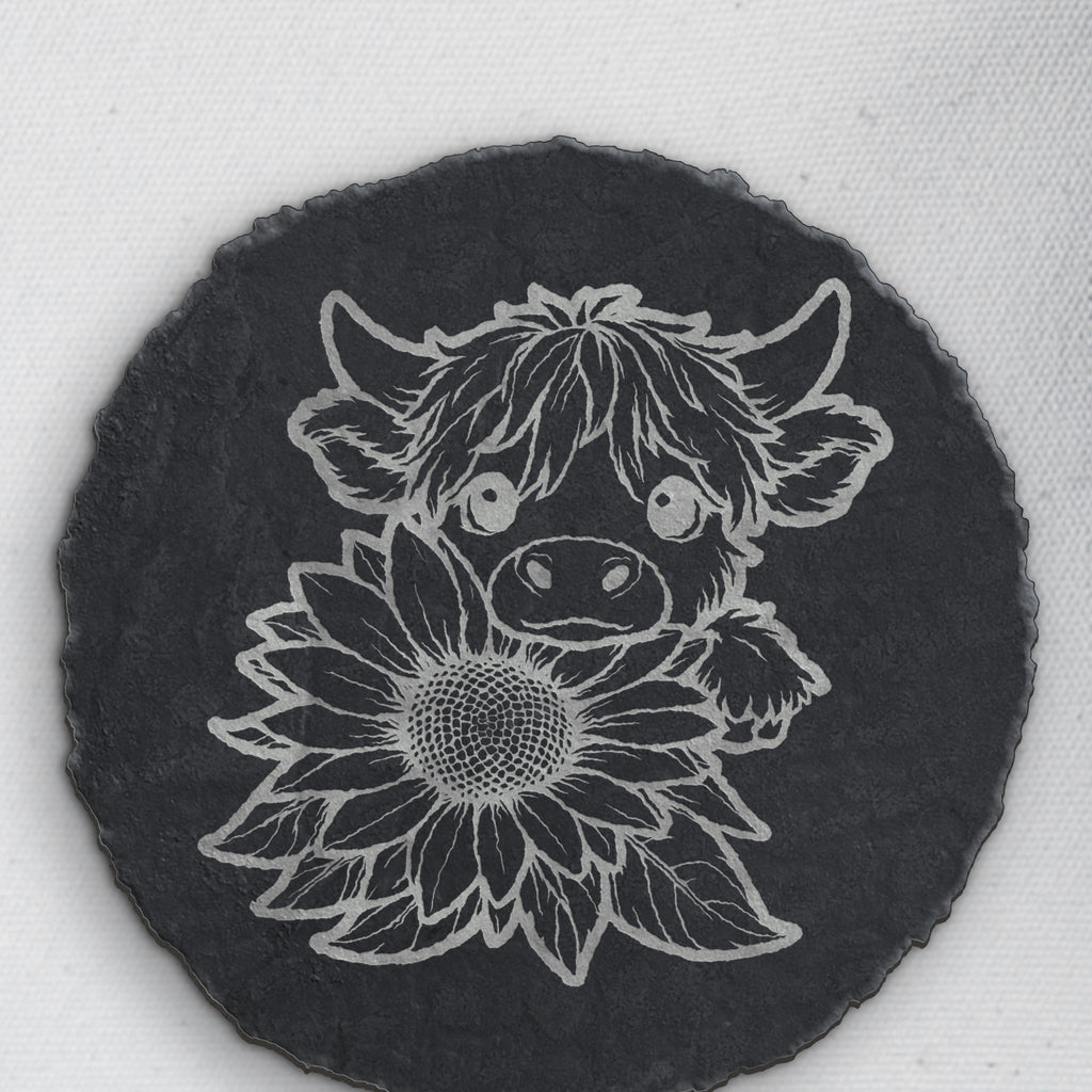Close-up of the highland cow and sunflower engraving on round slate (product mockup)