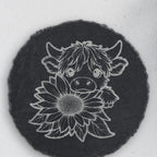 Close-up of the highland cow and sunflower engraving on round slate (product mockup)
