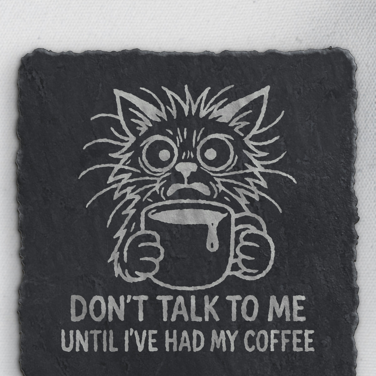 Close-up of the coffee cat engraving on square slate (product mockup)