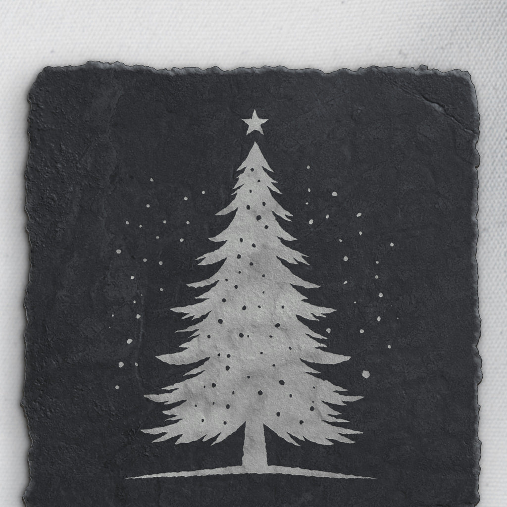 Snowy Christmas tree design on square slate, one of the four coasters in the mixed set (product mockup)