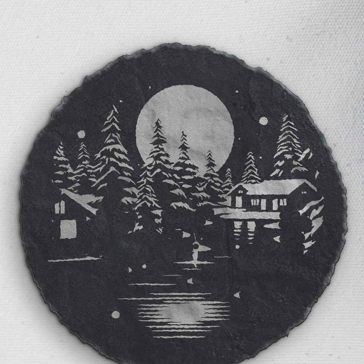 Winter cabin design on round slate, one of the four coasters in the mixed set (product mockup)