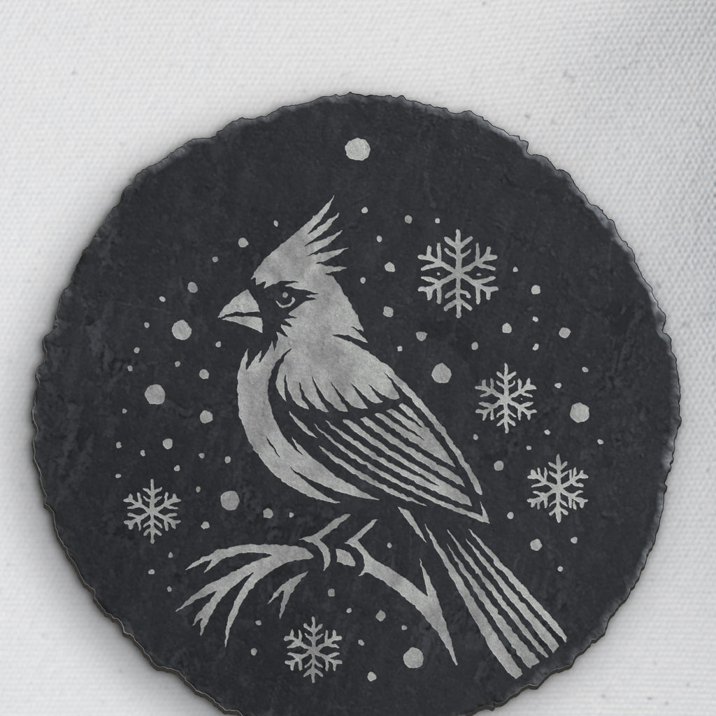 Close-up of the cardinal and snowflake engraving on round slate (product mockup)