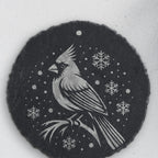 Cardinal in the snow design on round slate, one of the four coasters in the mixed set (product mockup)