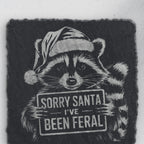 Close-up of the Santa-hat raccoon engraving on square slate (product mockup)
