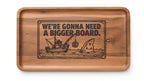 Top view of the engraved acacia serving tray with the We're Gonna Need A Bigger Board design inside the dish (real photo of our work)
