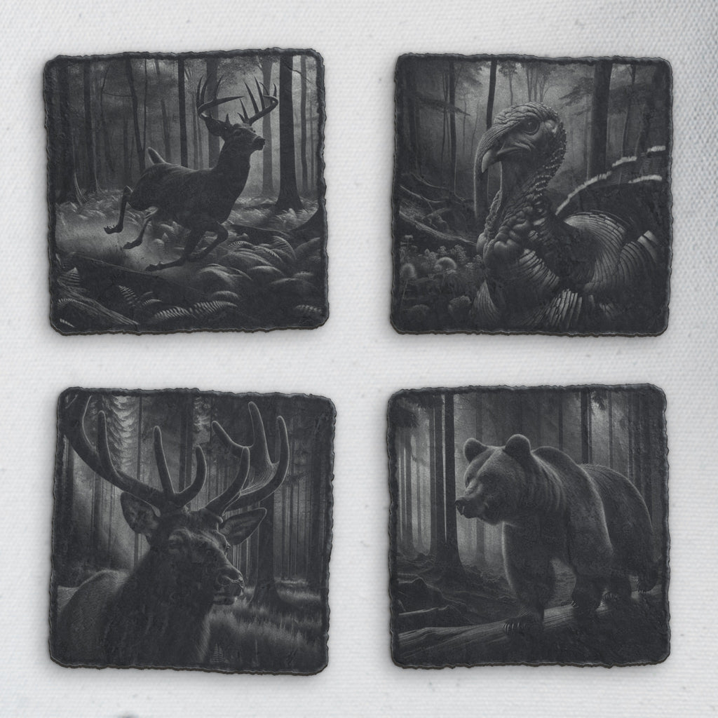 Four square slate coasters engraved with a running buck, a wild turkey, a bull elk and a bear in the forest (product mockup)