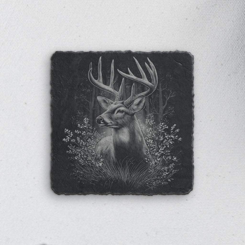 Square slate coaster engraved with a whitetail buck among forest trees and grasses (product mockup)