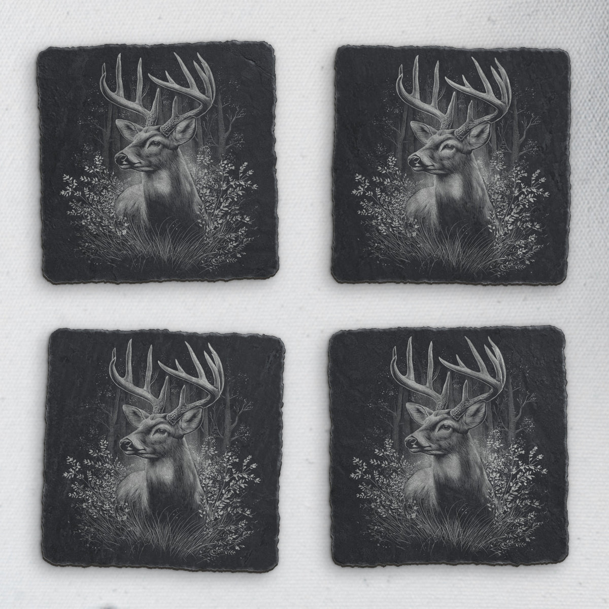 Set of 4 square slate coasters engraved with a whitetail buck in the forest (product mockup)