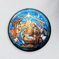 Round stained-glass-style nativity acrylic ornament with Mary, Joseph and baby Jesus under a bright star