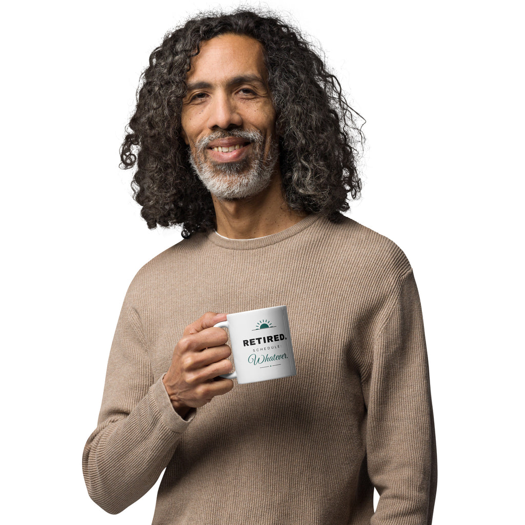 The same mug with the handle on the left, showing the matching "RETIRED. Schedule: Whatever." design on the other side.